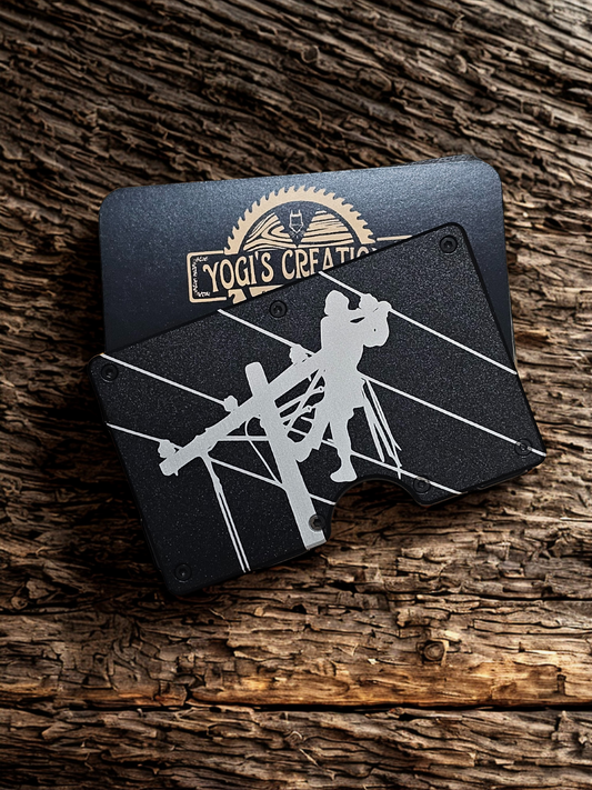 Black leather wallet with white design on a wooden surface, featuring 'Yogi's Creations' branding.