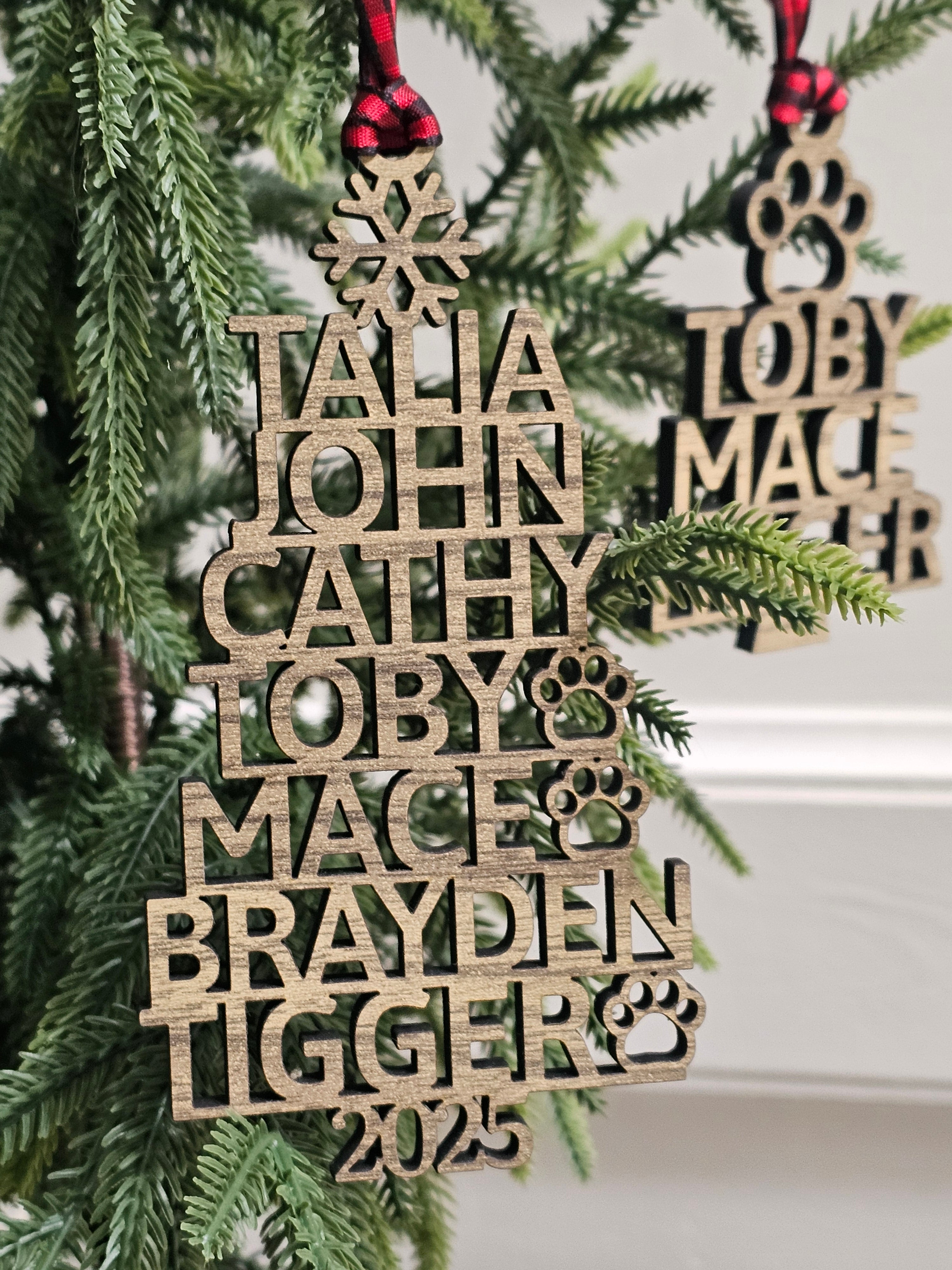 Wooden Christmas ornaments with names on a green tree
