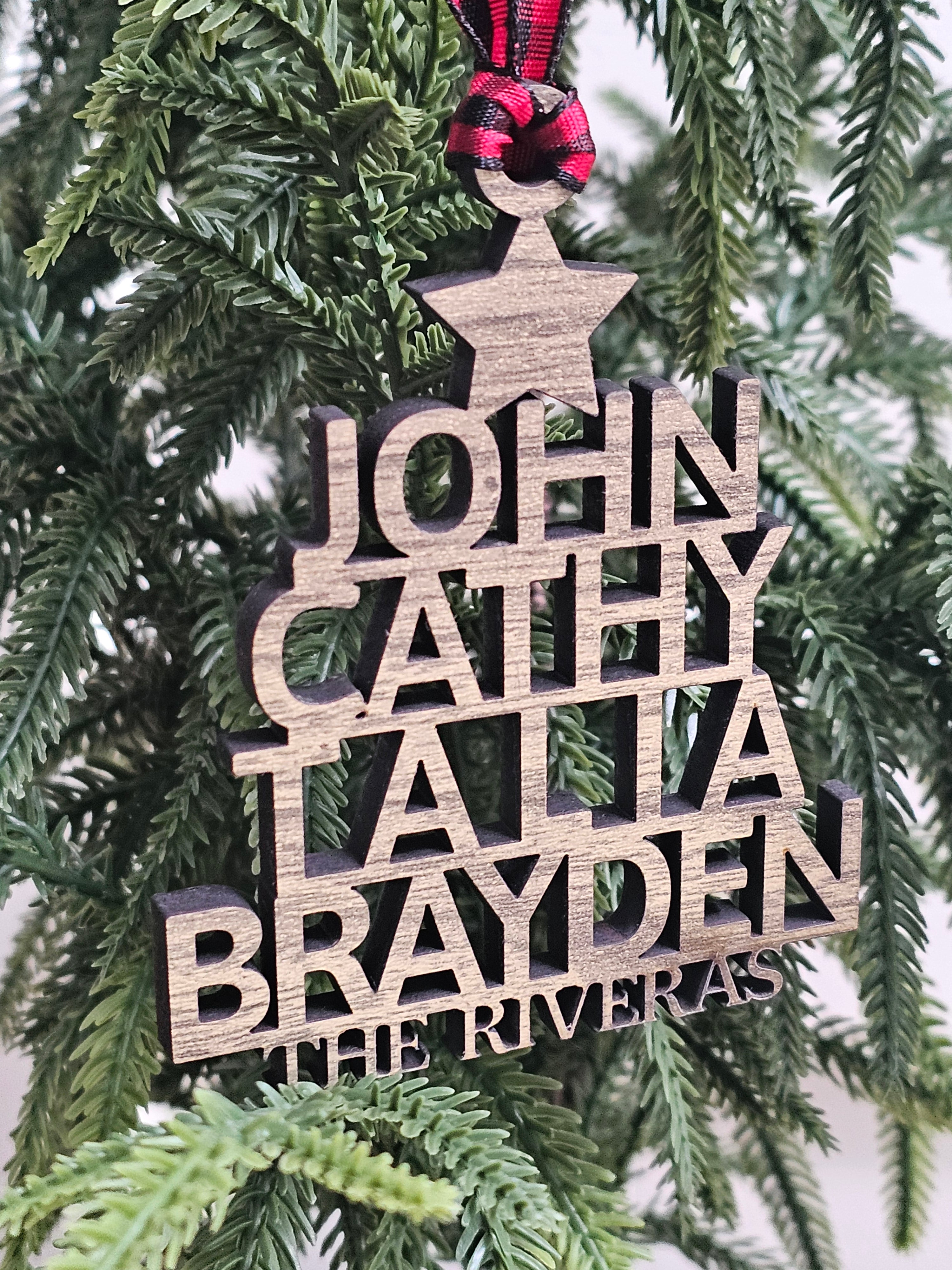 Wooden ornament with engraved names on a Christmas tree