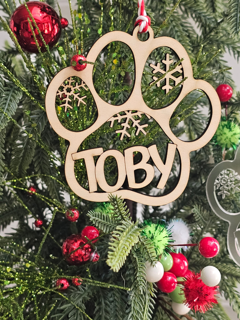 Wooden ornament with 'Toby' on a Christmas tree