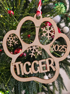 Wooden ornament with '2025' and 'Tigger' on a Christmas tree.