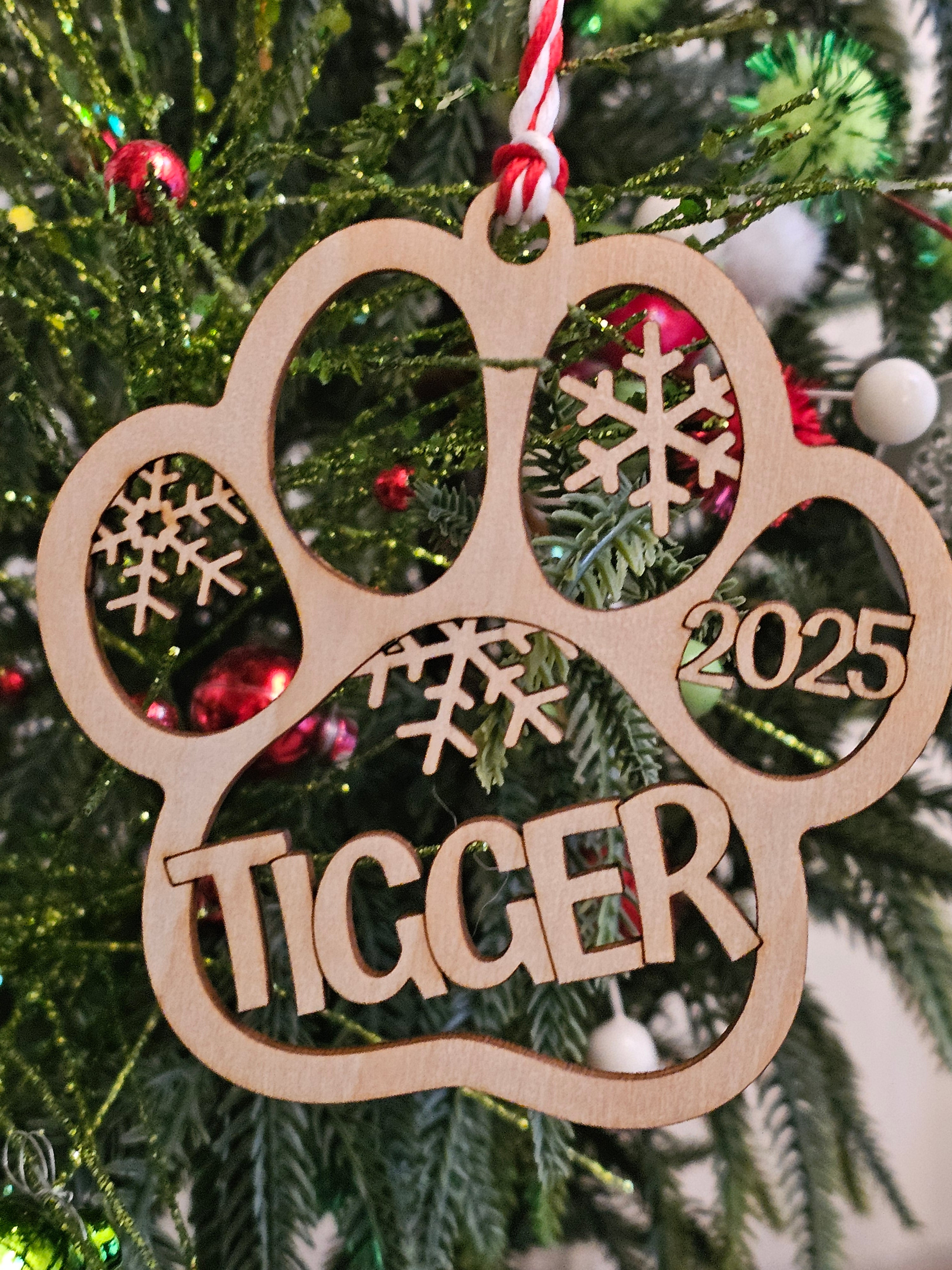 Wooden ornament with '2025' and 'Tigger' on a Christmas tree.