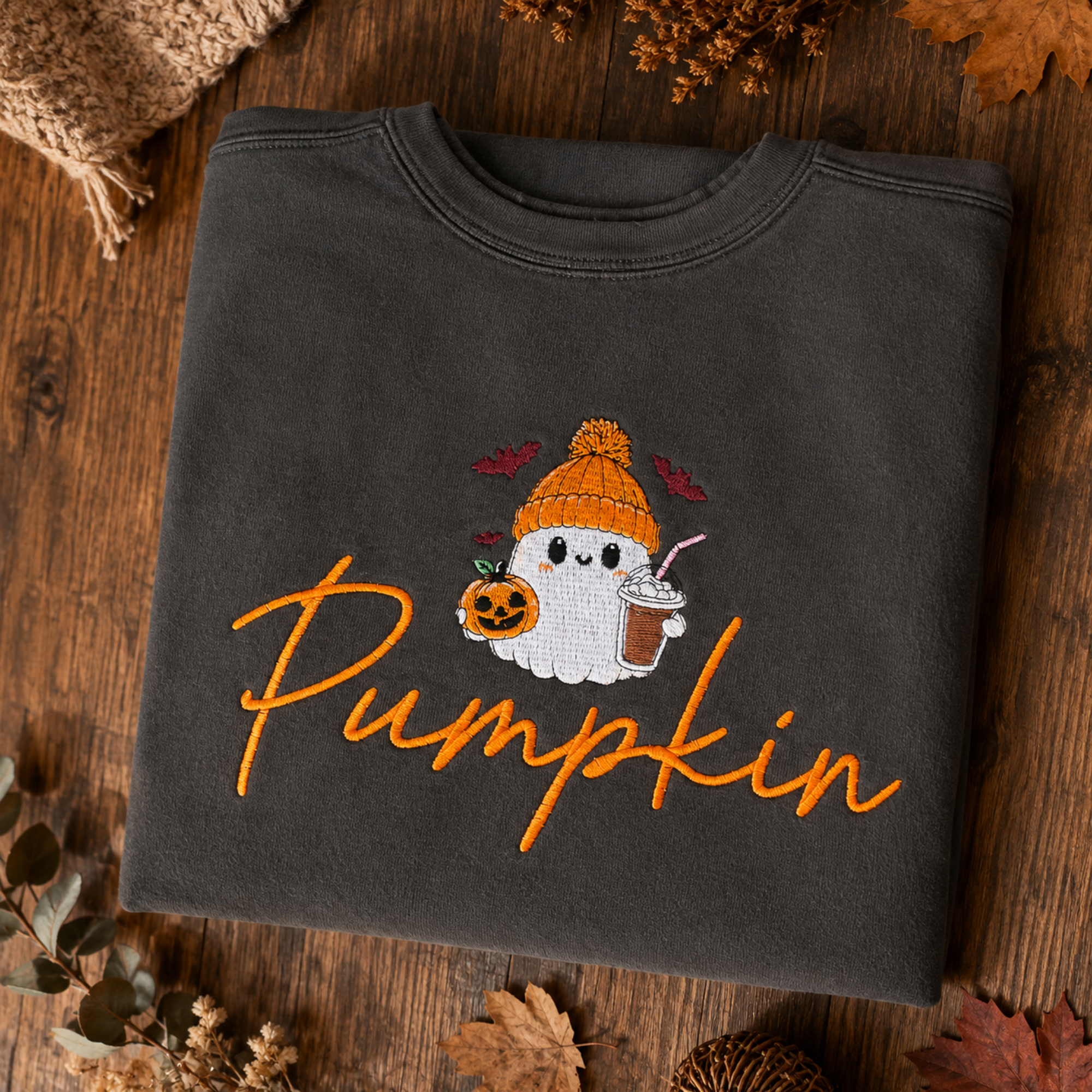 Woman modeling the Pepper Comfort Colors 1566 Pumpkin ghost embroidered sweatshirt