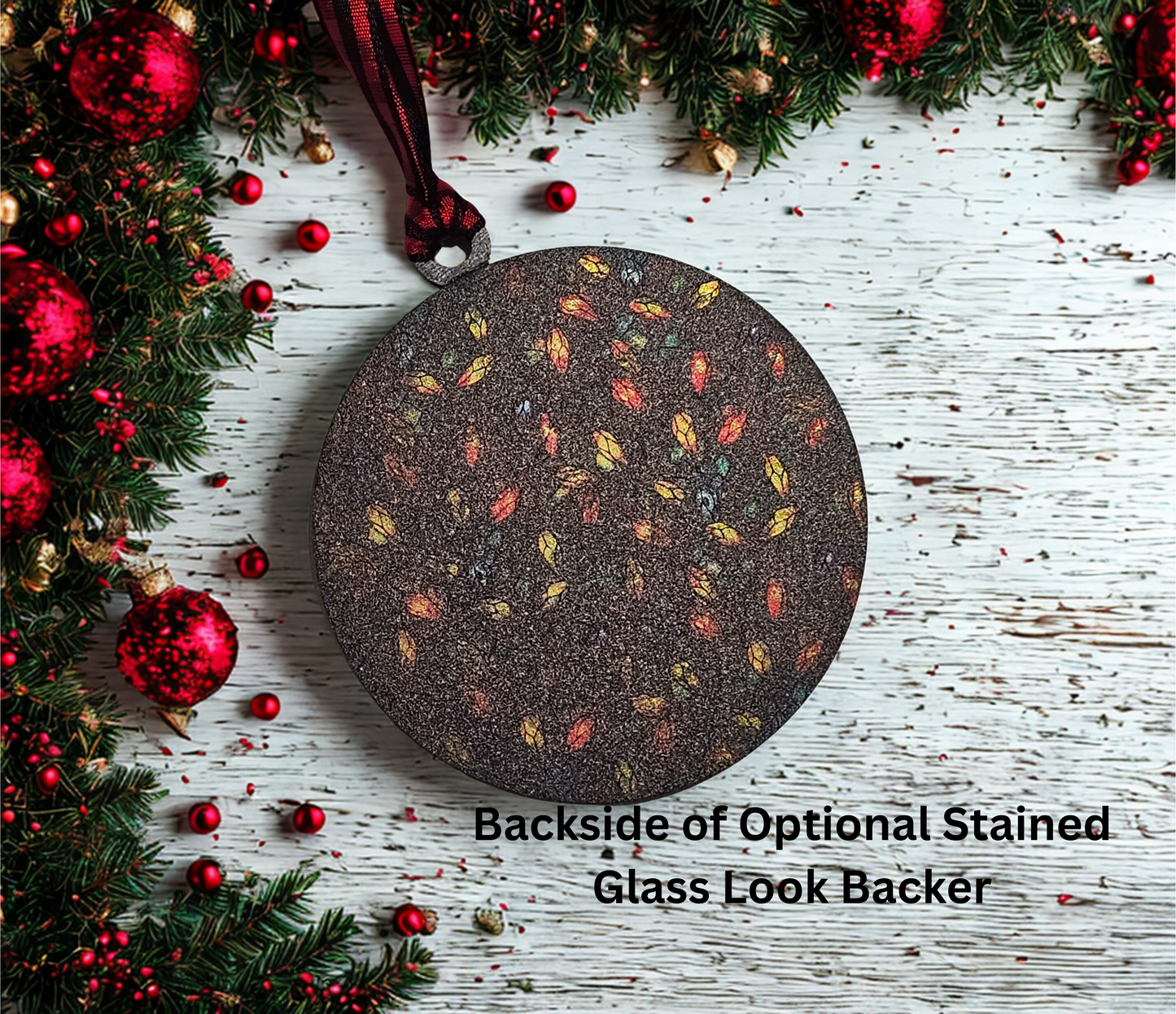 Decorative round object with stained glass pattern on a wooden surface with Christmas decorations.