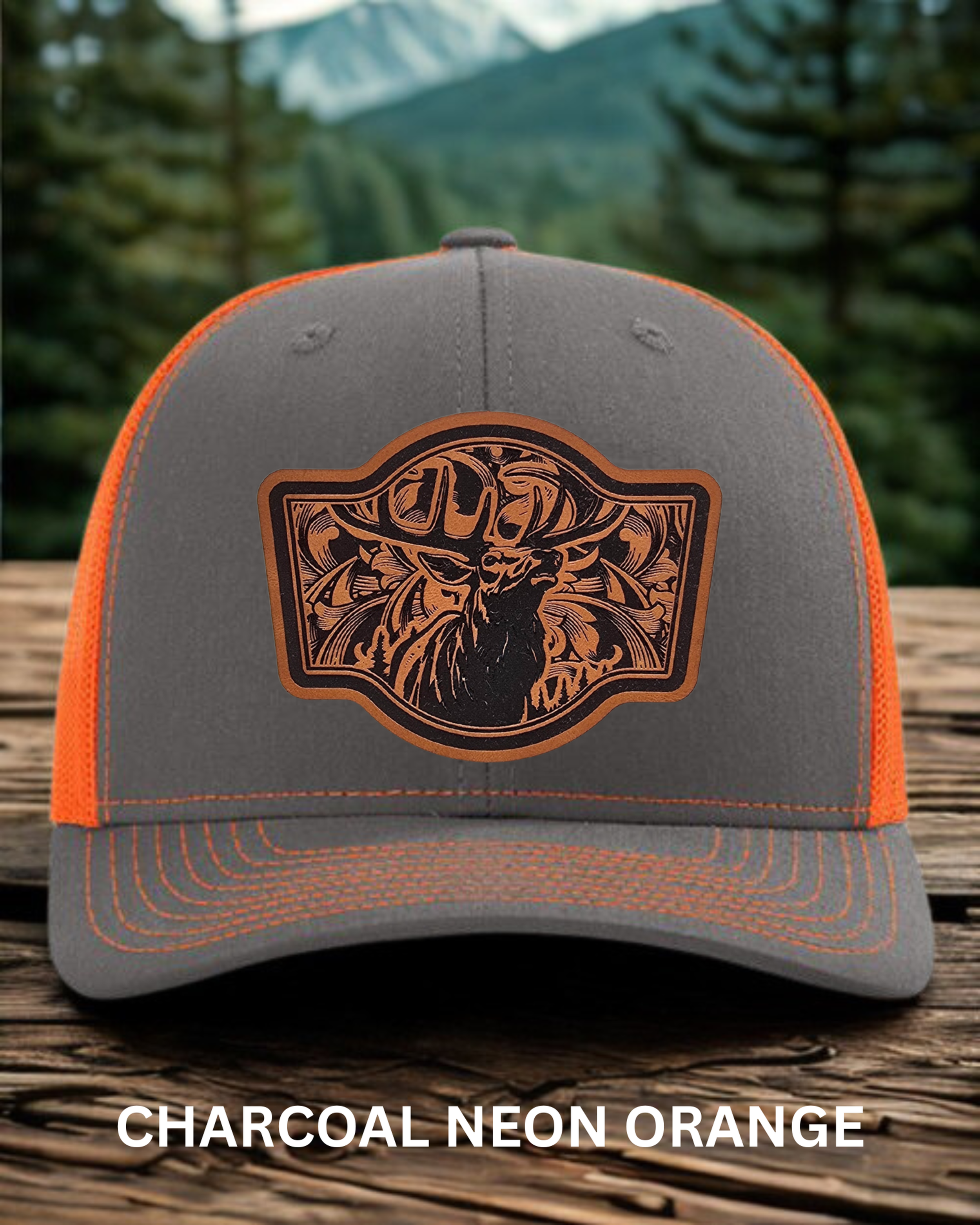 Gray and neon orange cap with a decorative logo on a wooden surface with a forest background