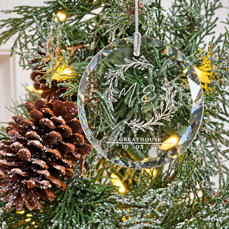 Close view of the personalized glass ornament showing its faceted beveled edge and engraving