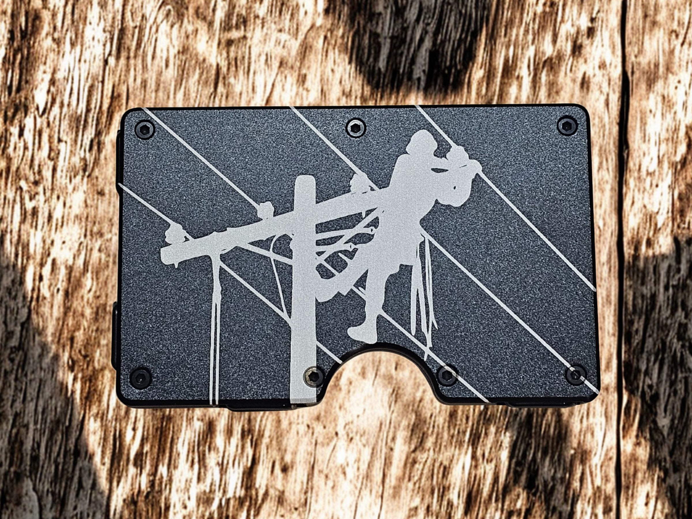 Black metal lineman wallet money clip with engraved climber design