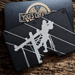 Black lineman wallet money clip with engraved utility worker design on rustic wood background
