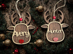 Wooden reindeer ornaments with 'Avery' and 'Hunter' names on a rustic wooden background.
