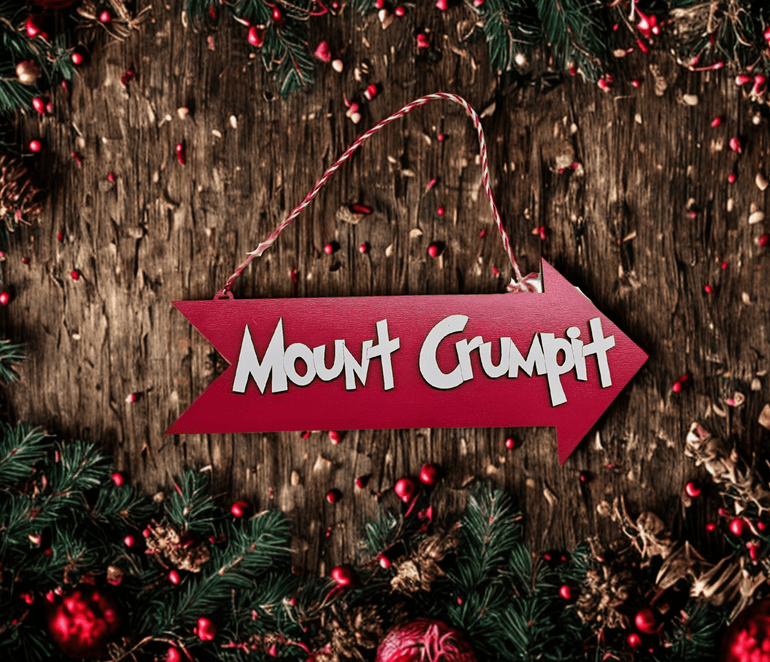 Whoville-style Christmas sign displayed near holiday tree decor
