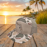 Angled view of sand camo Florida UV printed patch Richardson flat bill trucker hat