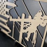 Angled close-up of personalized lineman flag plaque showing layered wood detail and black backing