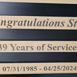 Close-up of custom text on a personalized lineman plaque for retirement and years of service