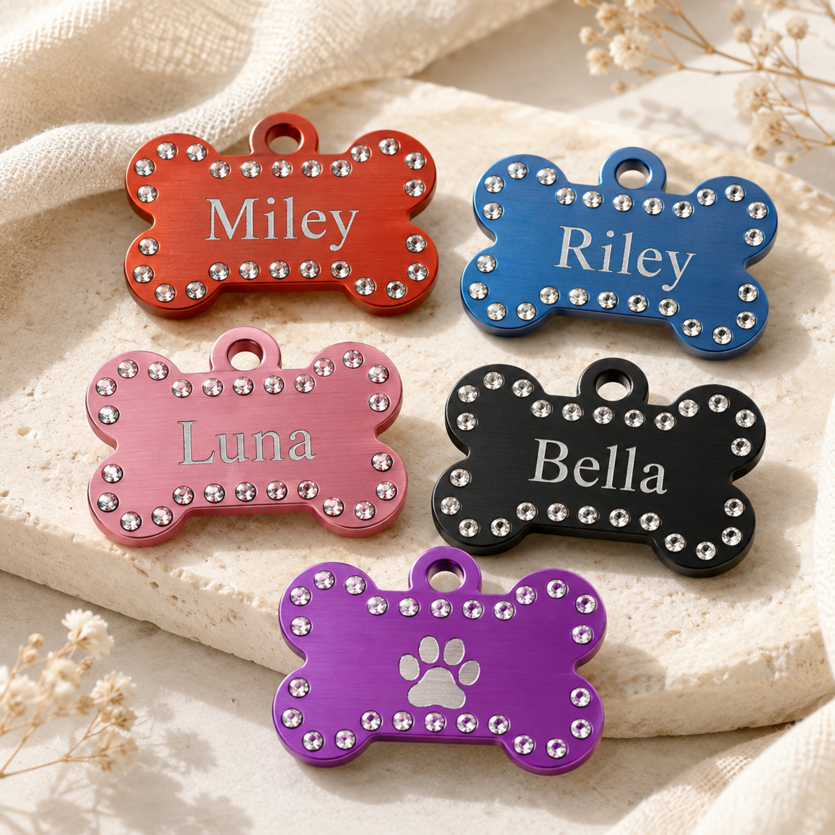 Personalized crystal pet ID tags with engraved names in multiple colors