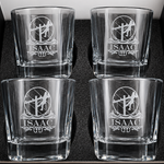 Four personalized lineman whiskey glasses with engraved designs arranged in a gift box