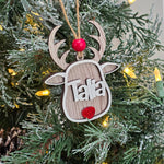 Whitewash personalized reindeer Christmas ornament with custom name hanging on a lit Christmas tree