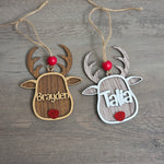 Personalized reindeer Christmas ornaments shown in Walnut and Whitewash wood finishes