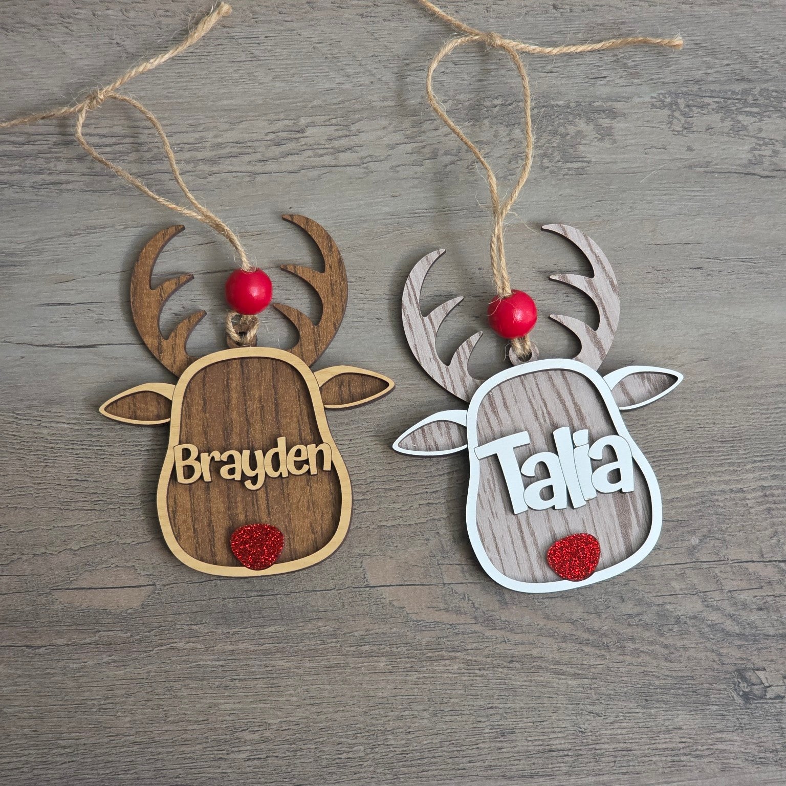 Personalized reindeer Christmas ornaments shown in Walnut and Whitewash wood finishes
