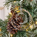 Personalized engraved wedding glass Christmas ornament with botanical wreath on a lighted tree