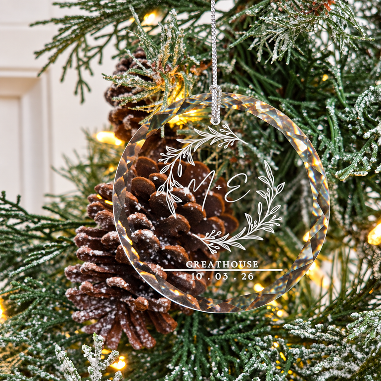 Personalized engraved wedding glass Christmas ornament with botanical wreath on a lighted tree