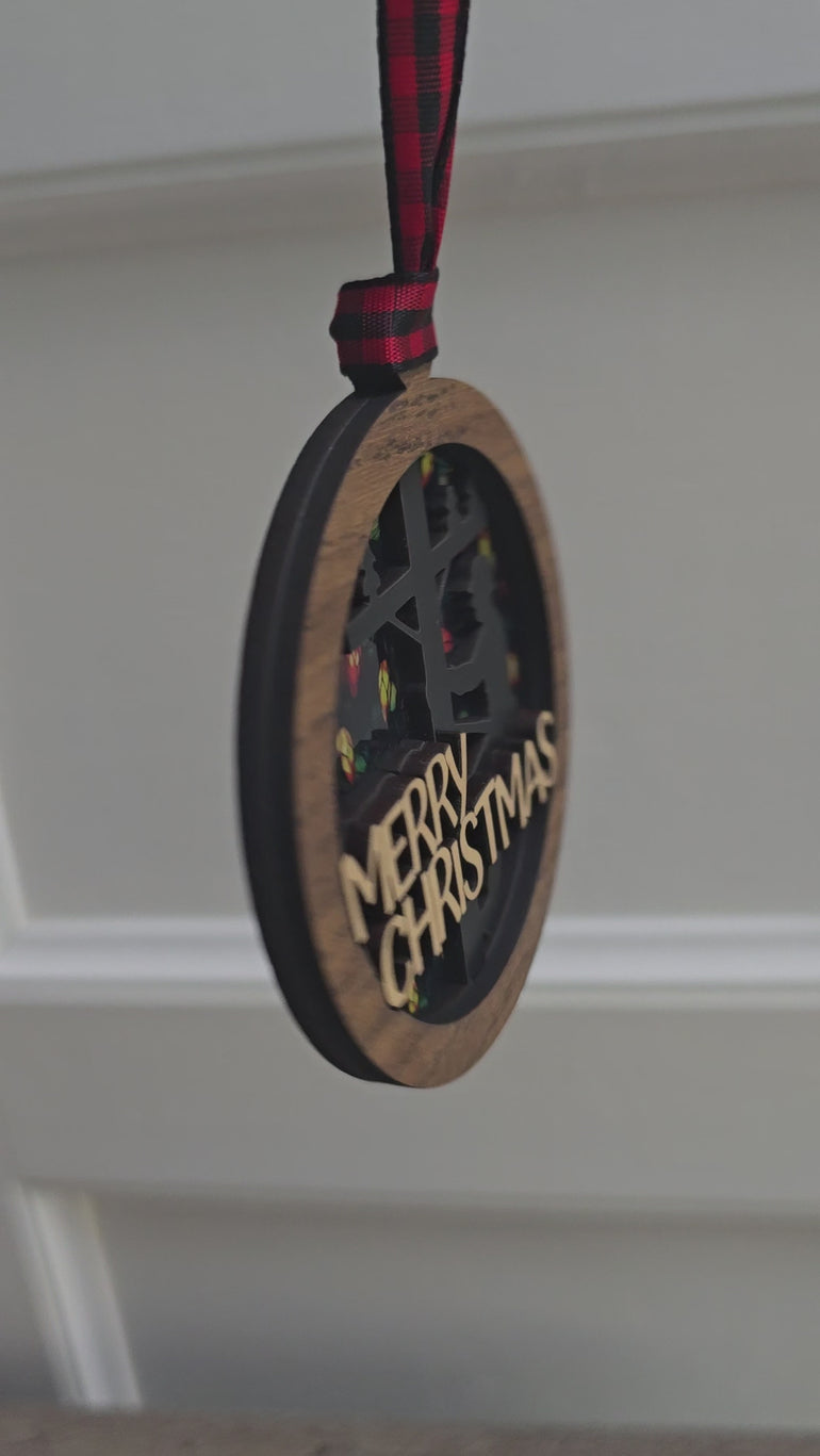 Side view of layered wood lineman Christmas ornament with ribbon hanger