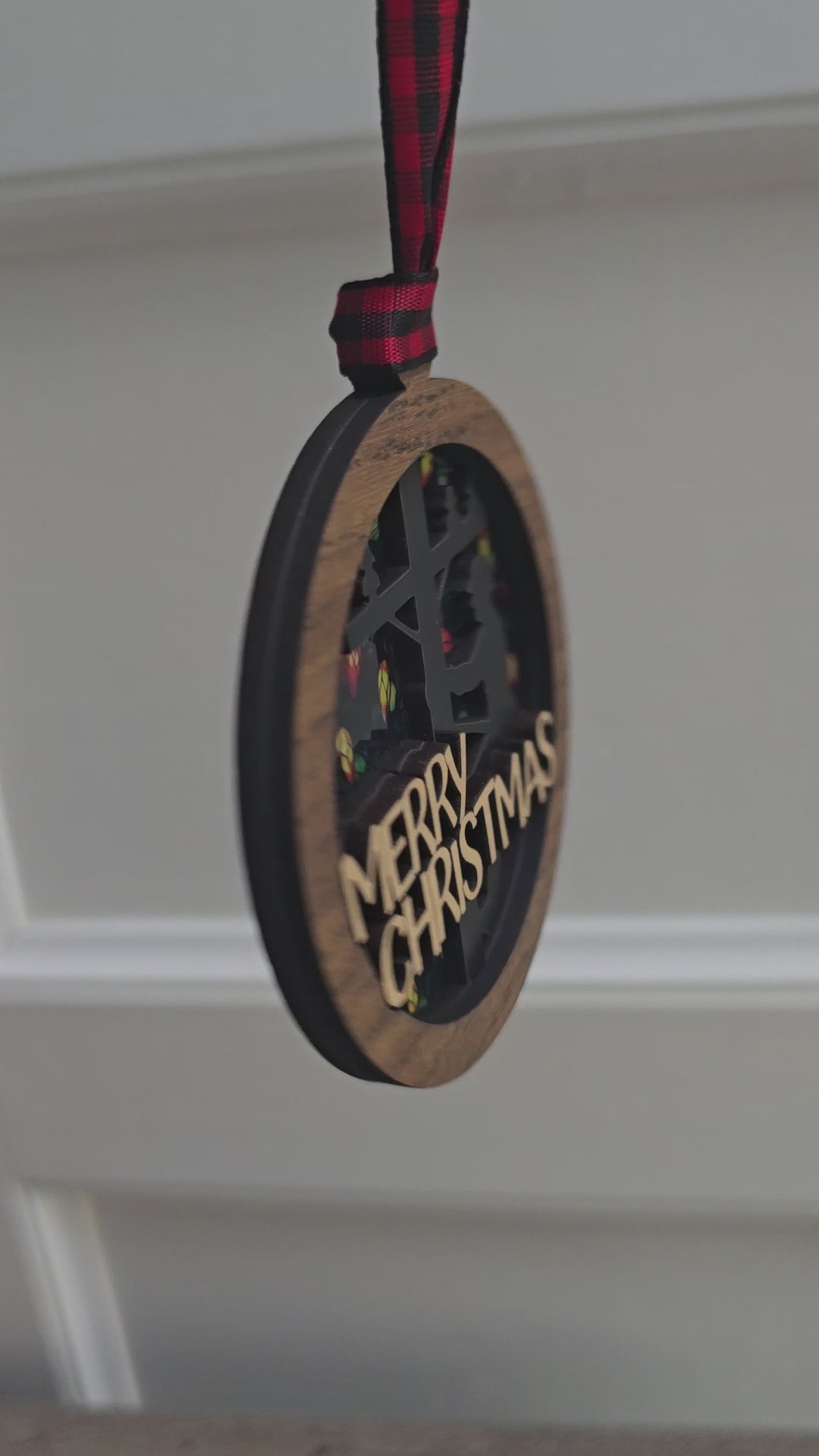 Side view of layered wood lineman Christmas ornament with ribbon hanger