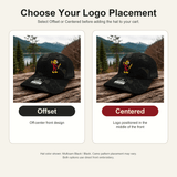 Infographic comparing Offset and Centered Reddy Kilowatt logo placement options on Multicam Black / Black Richardson hats
