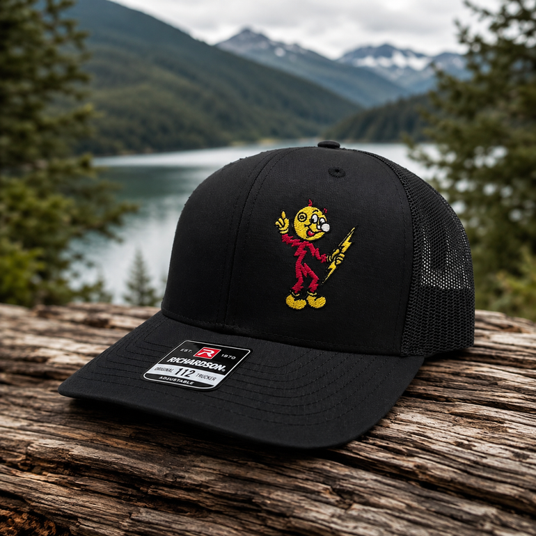 Reddy Kilowatt embroidered Black / Black Richardson 112 trucker hat outdoors