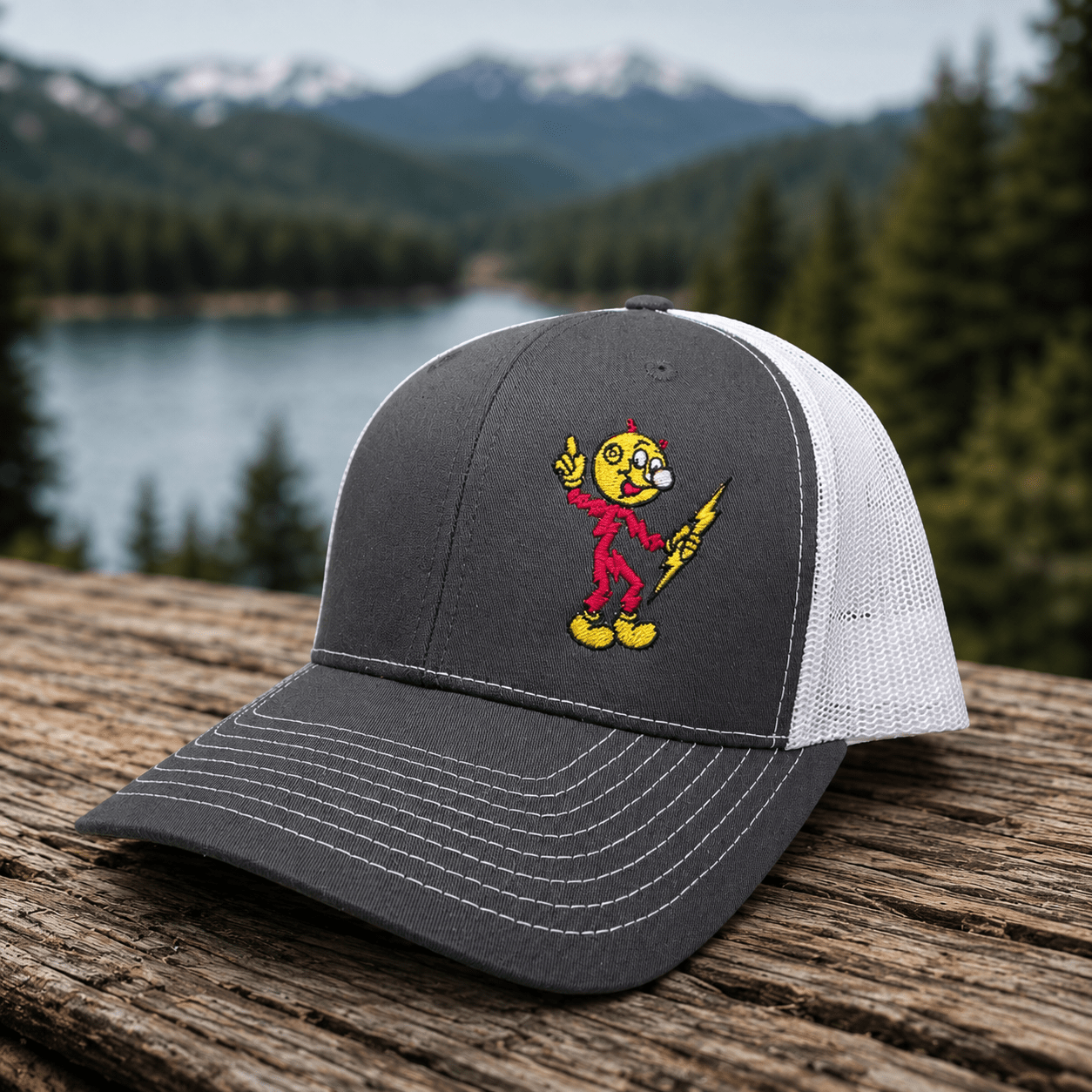 Reddy Kilowatt embroidered Charcoal / White Richardson 112 trucker hat outdoors