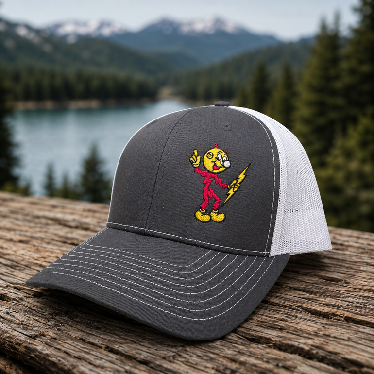 Reddy Kilowatt embroidered Charcoal / White Richardson 112 trucker hat outdoors