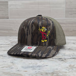 Actual Reddy Kilowatt embroidered Mossy Oak Bottomland and loden Richardson 112P trucker hat