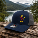 Reddy Kilowatt embroidered Navy / Charcoal Richardson 112 trucker hat outdoors
