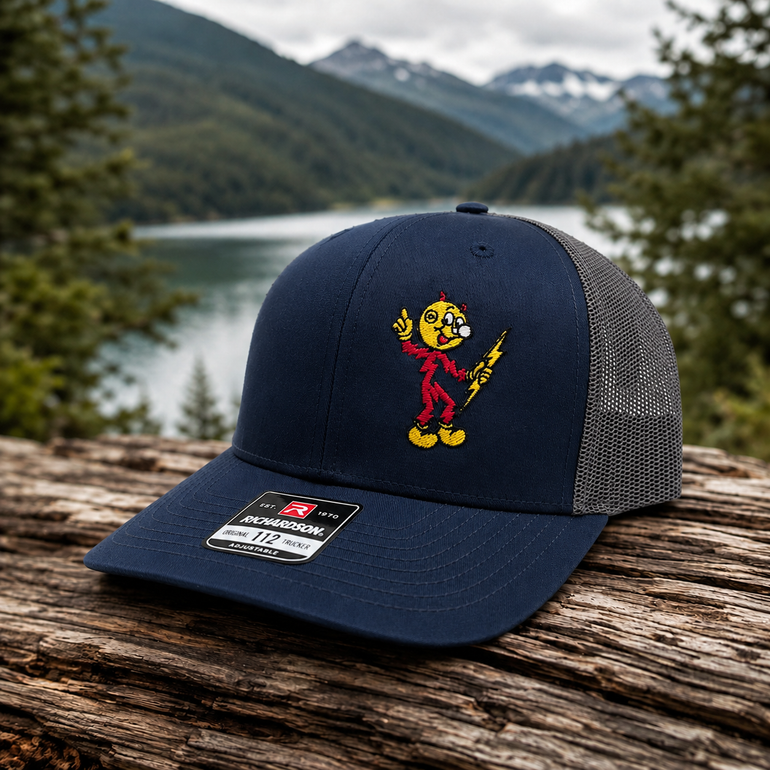 Reddy Kilowatt embroidered Navy / Charcoal Richardson 112 trucker hat outdoors