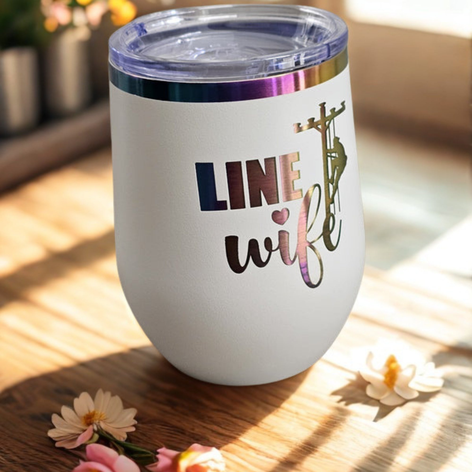White Linewife insulated cup with colorful prism design on warm wood tabletop
