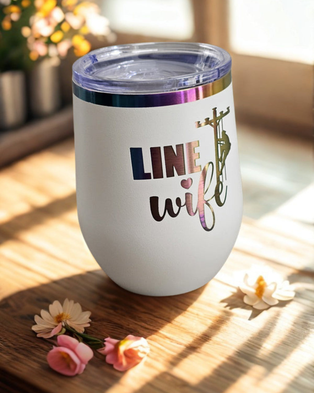 White Linewife insulated cup with colorful prism design on warm wood tabletop